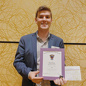 Daniel Kelly with his Delta Sigma Pi’s 2020 Pacific Coast Regional Collegian of the Year certificate