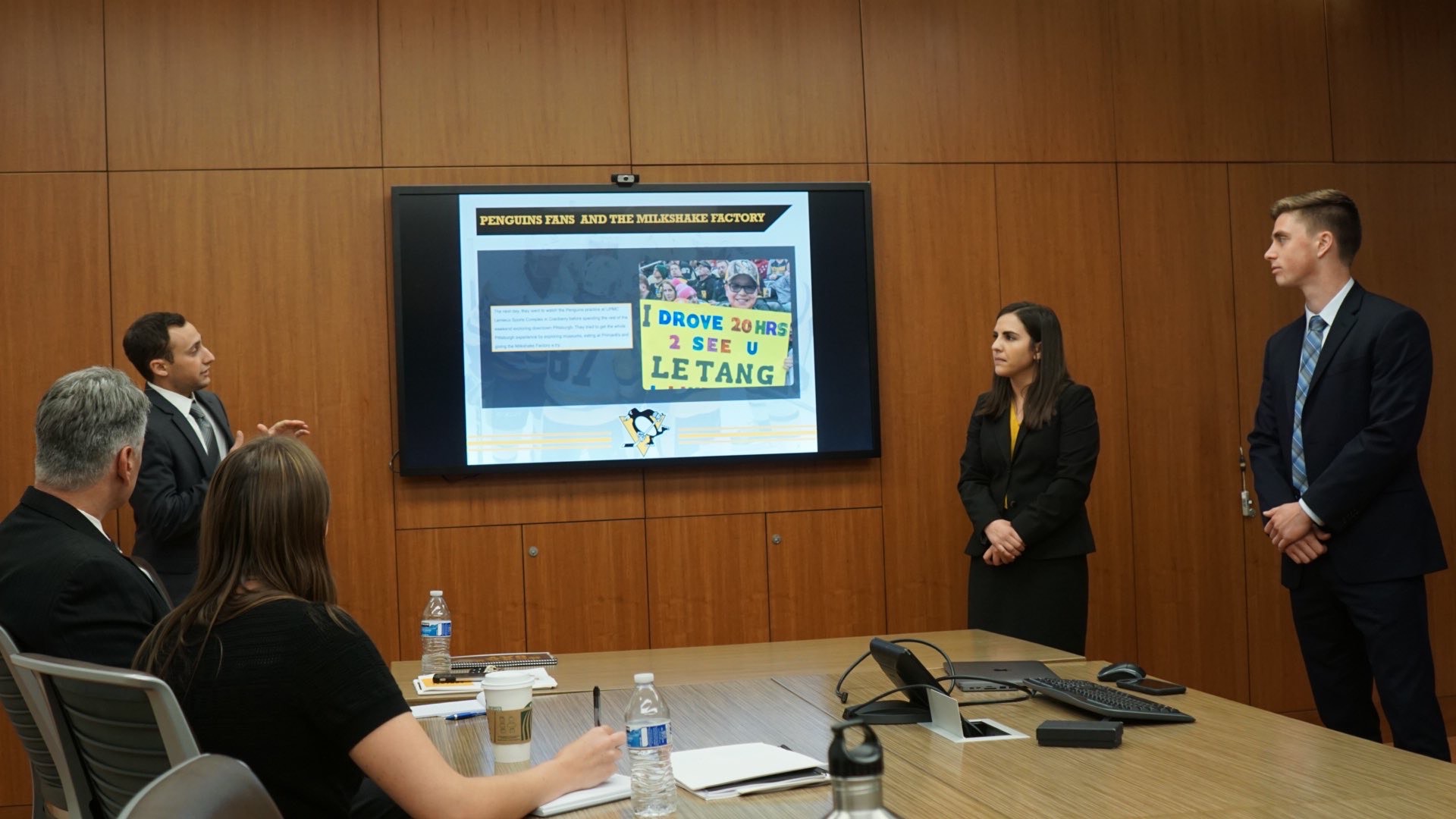 Morgan Pefanis (center) presents a fan activation project to the Pittsburgh Penguins with SMBA '20 classmates.