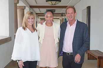 Ellen (left) and Steven Osinski (right) stand next to Olympic track star Allyson Felix