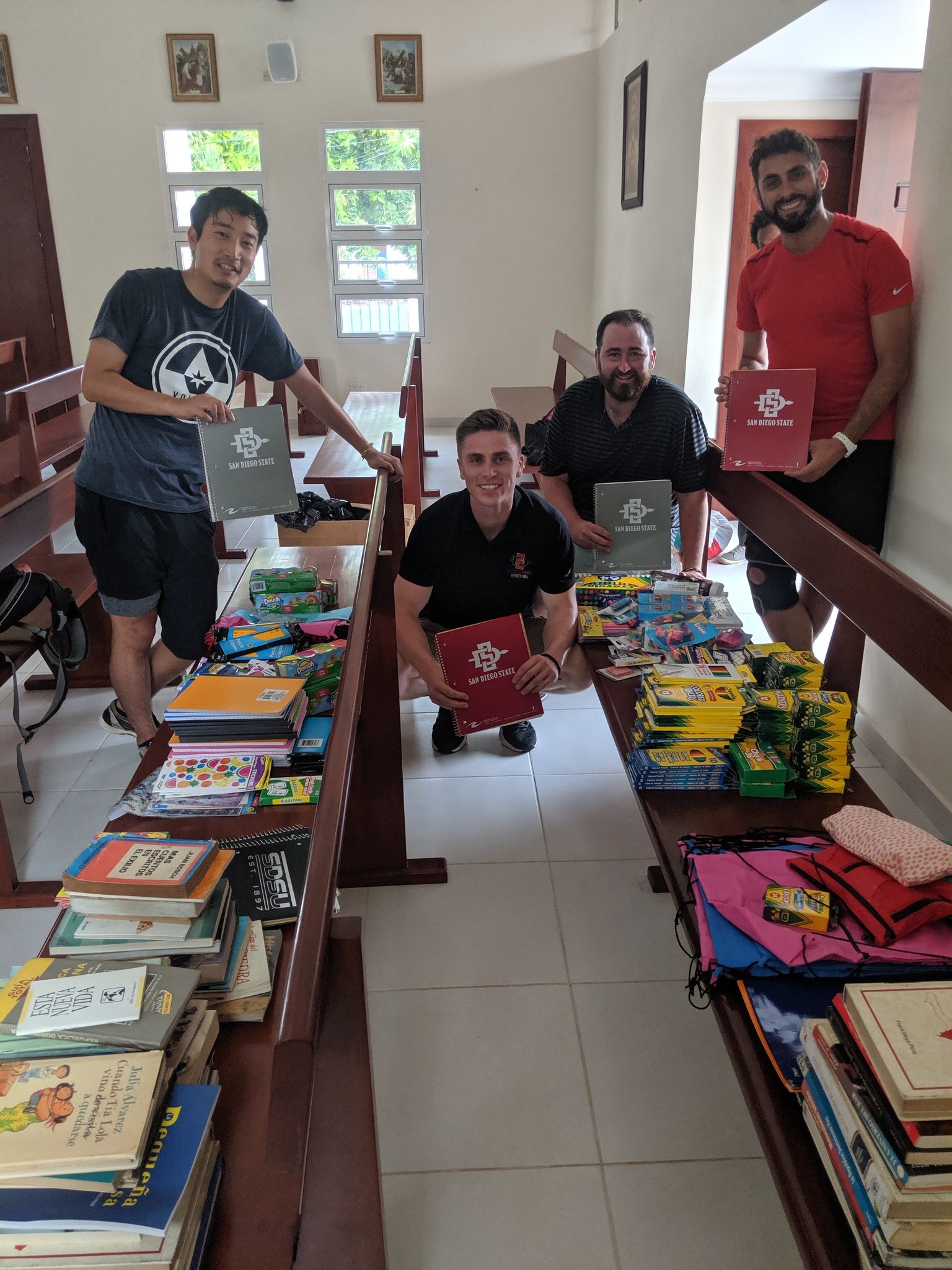 Scott Patterson (second from left) poses with donated SDSU school supplies during the program's international trip to the Dominican Republic.