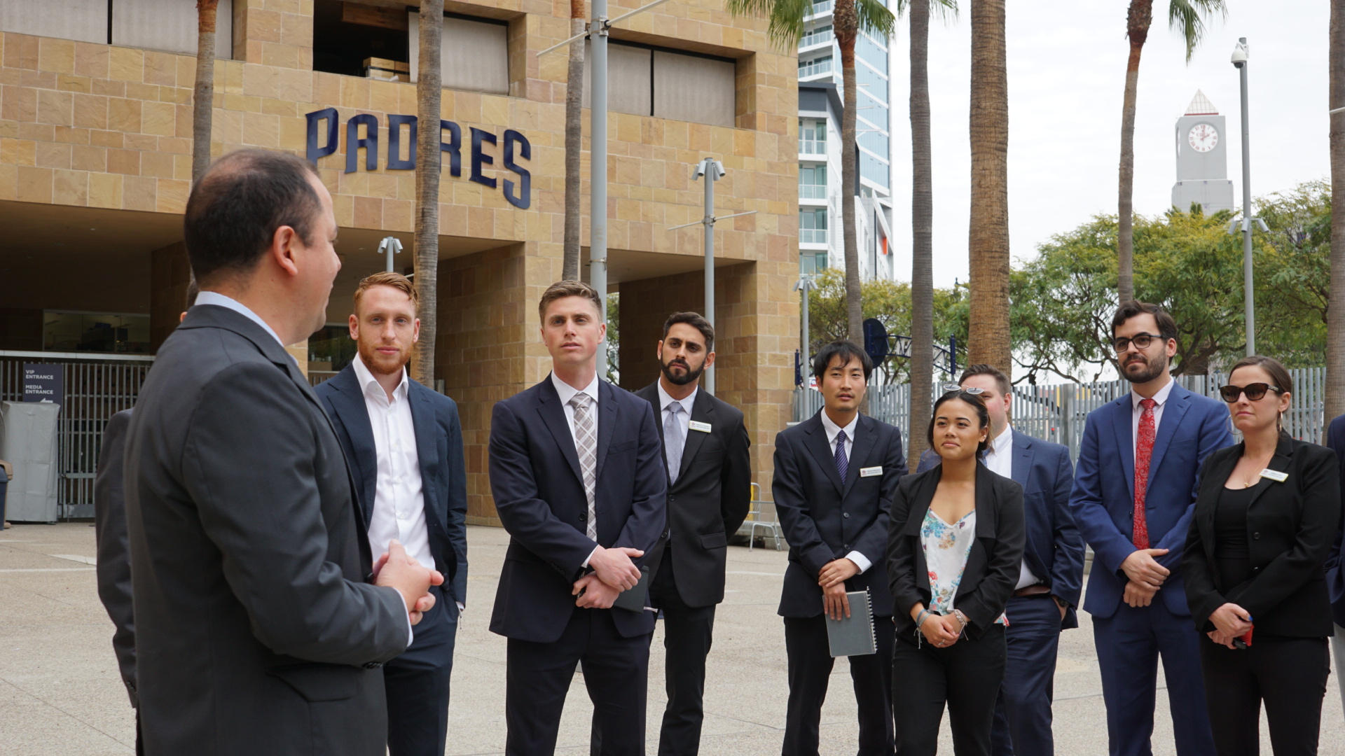 Scott Patterson (third from left) listens with fellow classmates to Roberto Castro (SMBA '11) during a tour of Petco Park. 