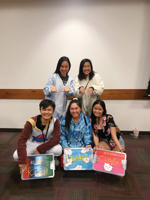Nguyen poses for a photo at the Kuya Ate Ading (KAA) reveal, the mentorship program with AB Samahan. Kuyas are male mentors, Ates are female mentors and adings are the coed mentees. Pictured are Khai’s ates Rachel and Audrey! His twin ading is Cindy.