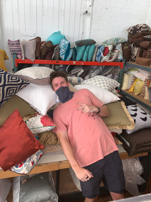 Jack Peabody tests the throw pillows in the Humble Design warehouse.
