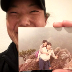 Tiffany Joh Holds up a Photo of her Parents