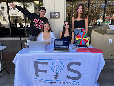 Executive board members representing FIS and meeting new students.