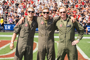 Fowler alumnus, Christopher Willis (right), with fellow Marine Corps aviators Bentley and Silvia on the field of Snapdragon Stadium shortly after their flyover (Courtesy of SDSU)