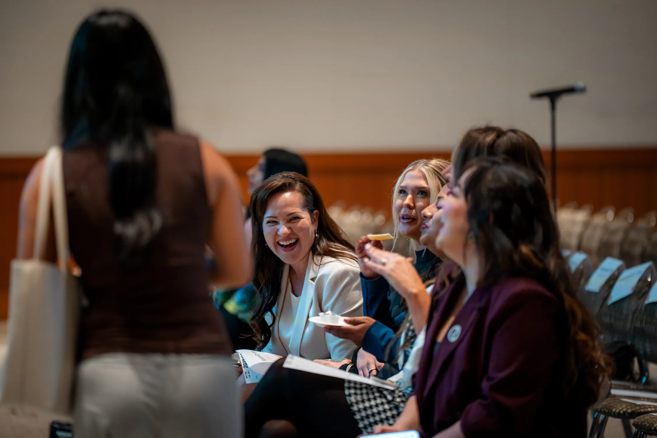Women in Leadership Conference 2025 panelists interacting with attendees