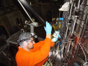 Pace takes a measurement during a diagnostic installation at the DIII-D lab